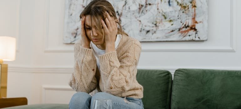 Woman sitting on the couch and worrying about can you overdose on DMT.