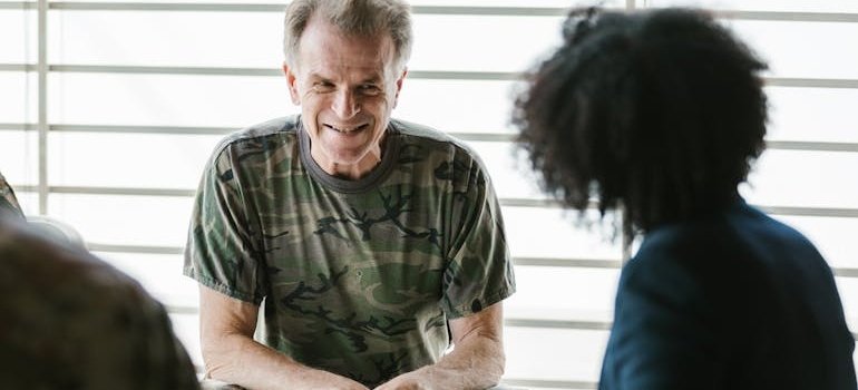 Veteran smiling while talking with his therapist.