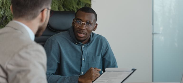 Man talking to his employer about starting rehab.