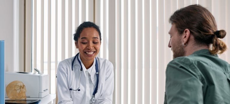 Man talking about his PTSD and alcohol abuse with a doctor.