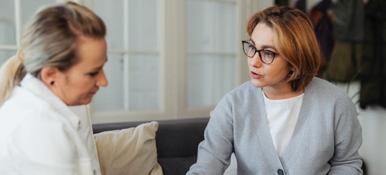 Woman supporting her friend who is struggling with PTSD and alcohol abuse issues.