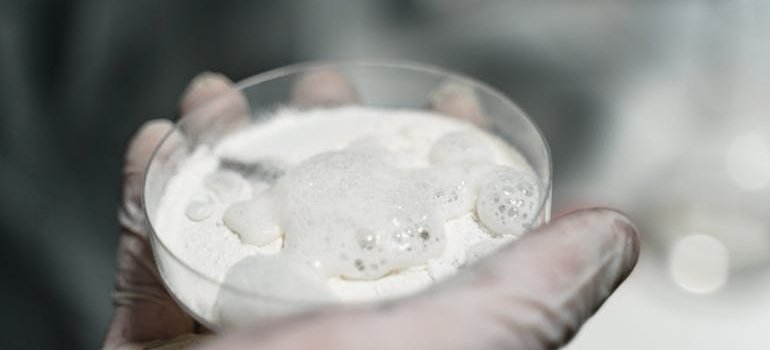Scientist holding a petri dish filled with fentanyl laced heroin.