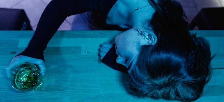 Woman passed out on a bar after mixing codeine and alcohol.
