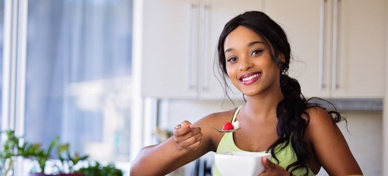 Woman eating a fruit salad.