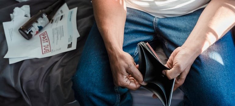 Man opening an empty wallet.