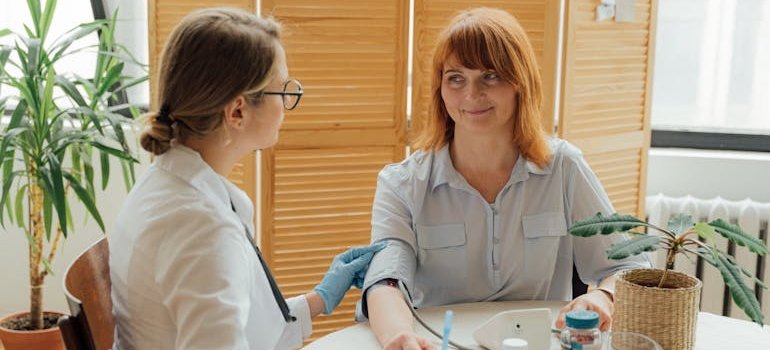 Woman getting her blood pressure checked by a doctor.