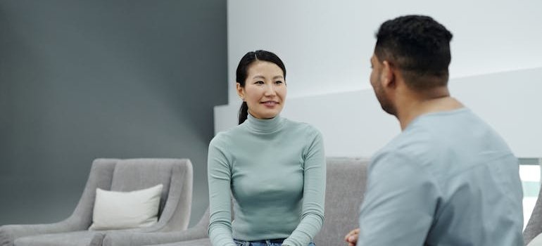 Woman smiling and talking to a doctor.