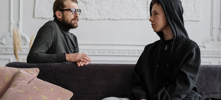 Therapist explaining how to talk about trauma in therapy with his patient.