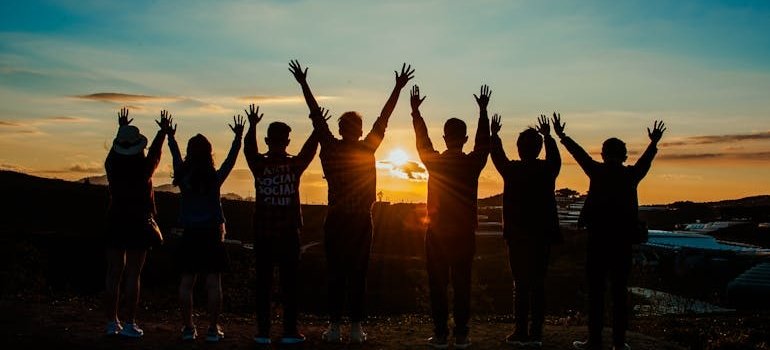Group of people looking at a sunset.
