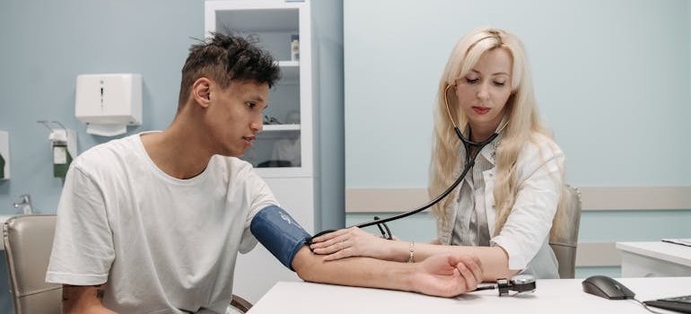 Doctor measuring a man's blood pressure.