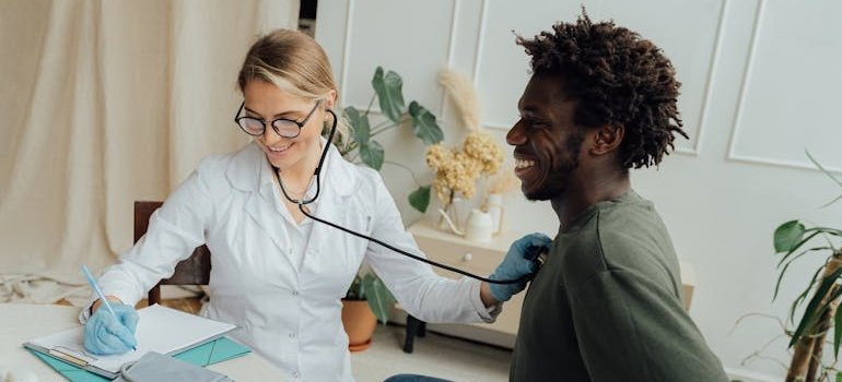 Doctor doing a medical checkup for a man before entering tailored detox programs.