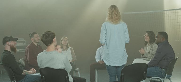 People in a peer support group talking about life after inpatient rehab.