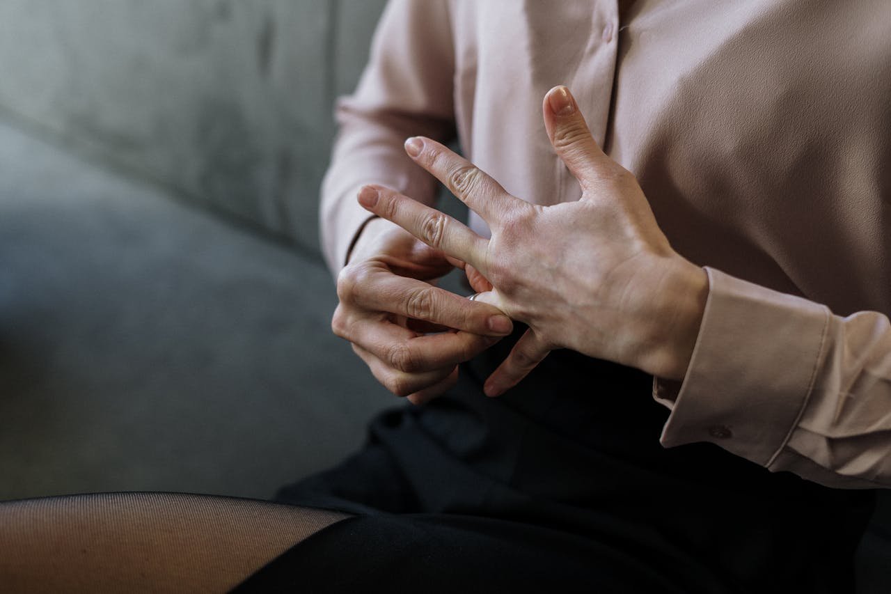 Woman taking off her wedding ring.