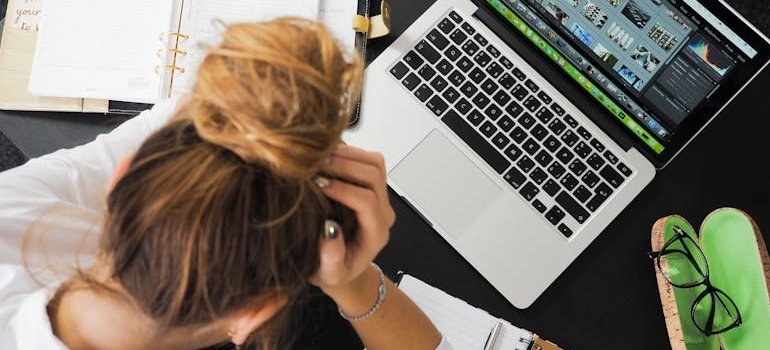 Stressed out woman looking at her laptop.
