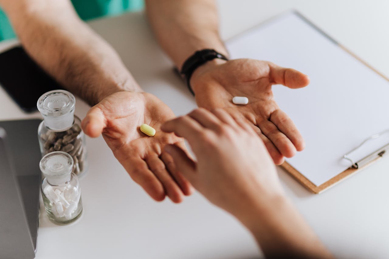 Doctor holding two types of pills.
