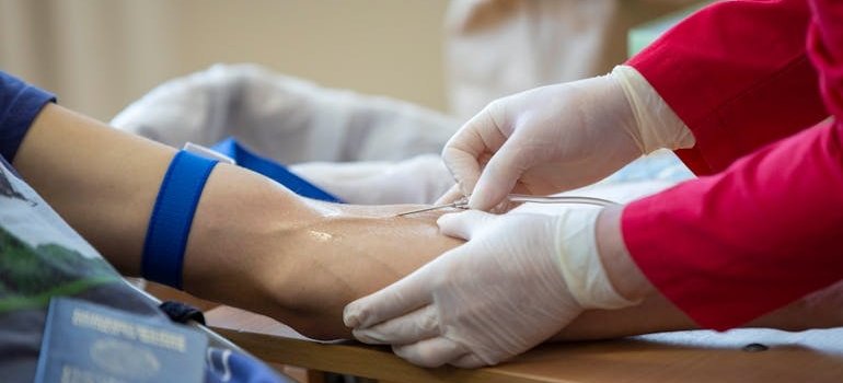 Nurse putting an IV into a patient.