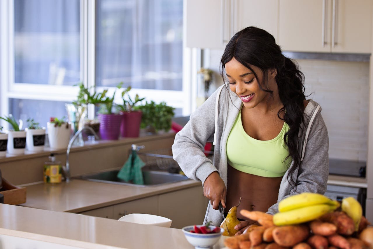 Woman making a healthy meal while worrying about both nutrition and mental health.
