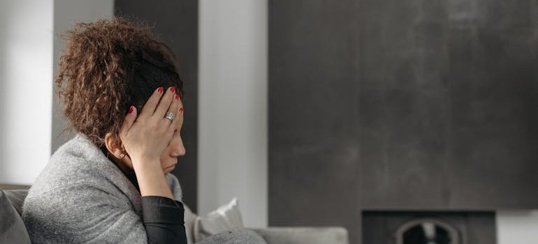 Woman sitting on the couch and feeling sick.