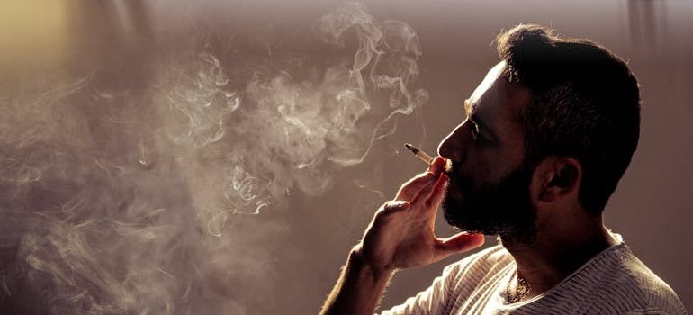 Man smoking marijuana and living a California sober lifestyle.