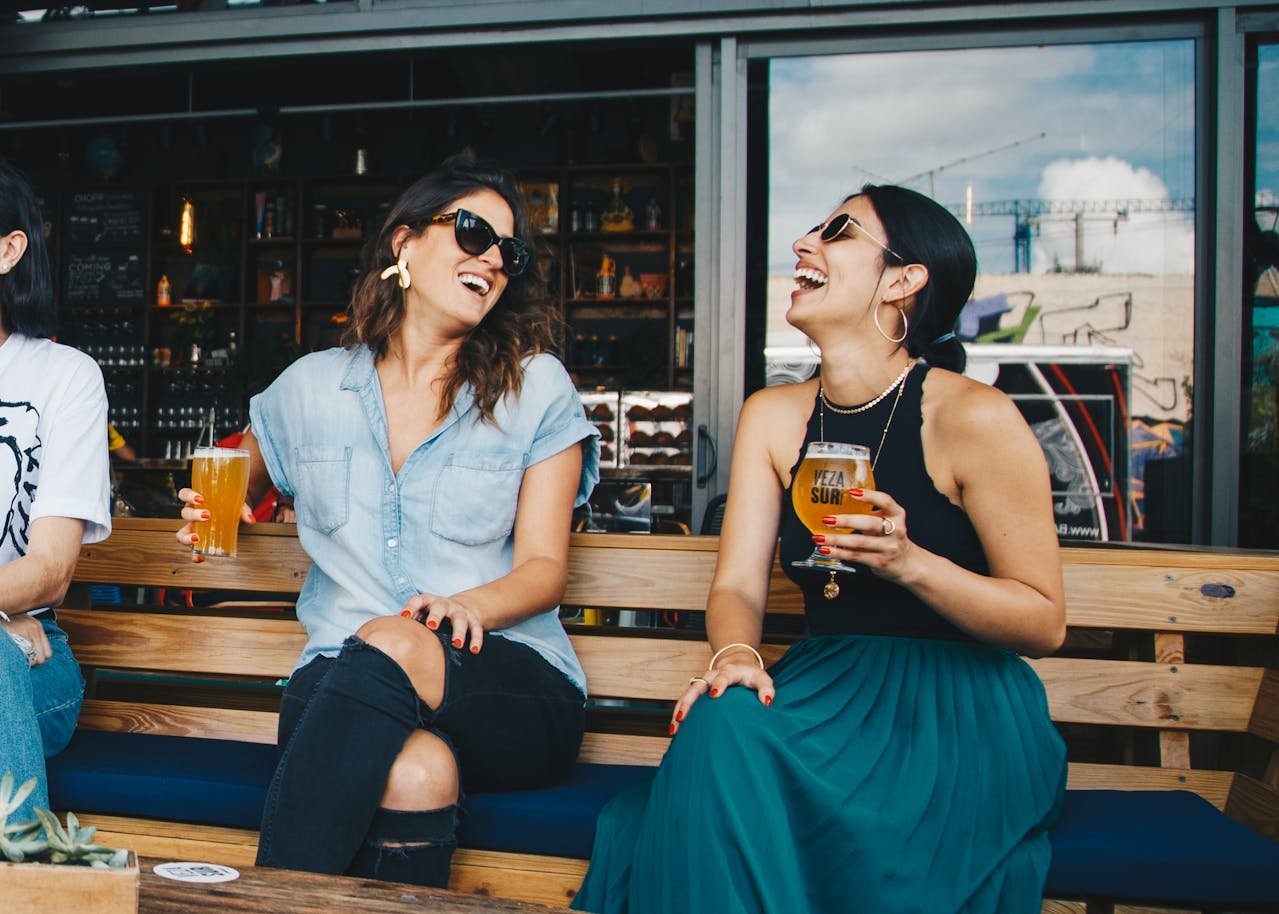Women sitting at a pub and drinking beer.