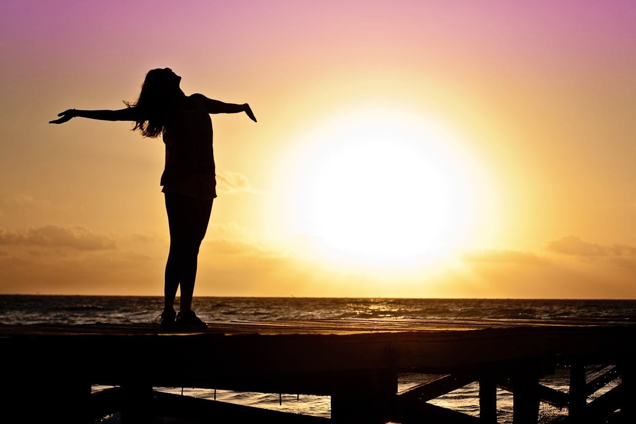 Woman looking at the sun while learning how to rebuild your life after rehab.
