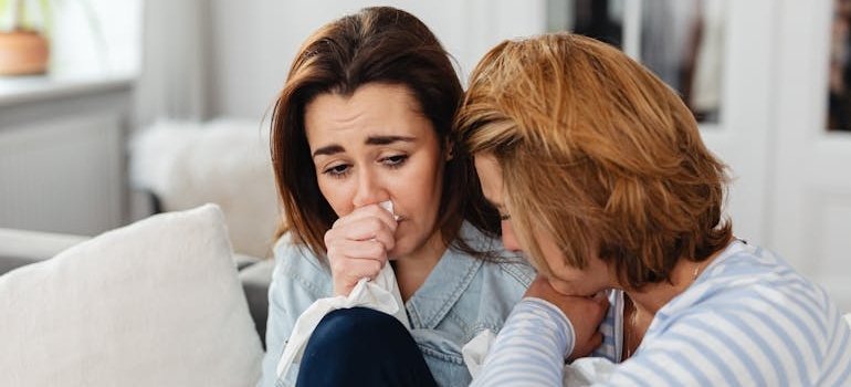 Two women crying and hugging.