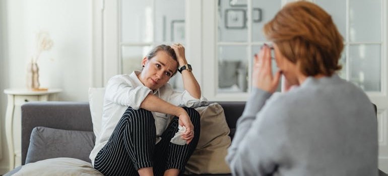 Woman crying and talking to a therapist.