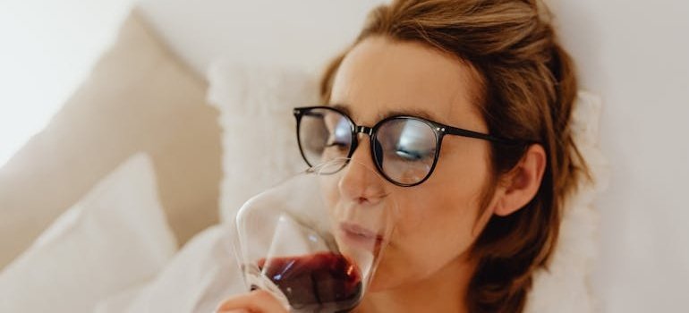 Woman drinking a glass of wine.