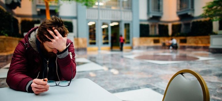 Stressed out man holding his head.
