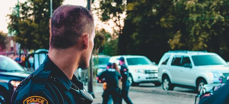Police officer looking at an arrest being made.