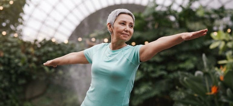 Older woman doing outdoor yoga.