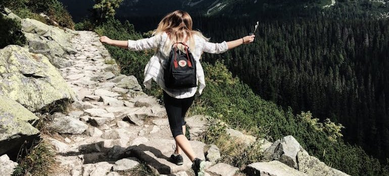 Woman hiking in the hills to better her mental wellness.