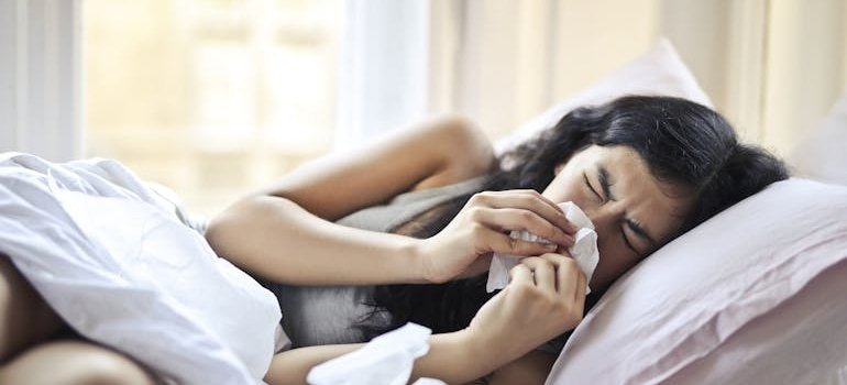 Woman wiping her nose after getting a nosebleed from cocaine.