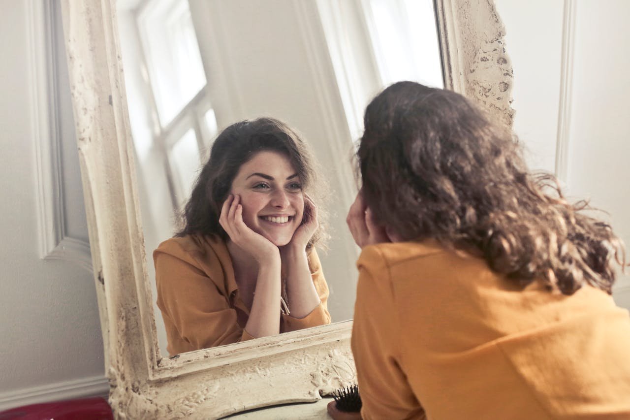Woman looking at herself in the mirror.