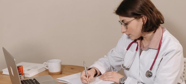 Doctor writing a prescription for a medication.