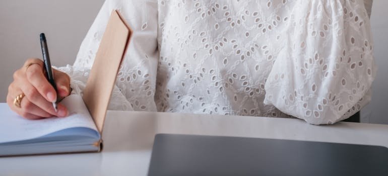 Person writing in a notebook.