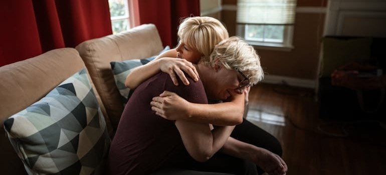 Mother and daughter hugging each other.