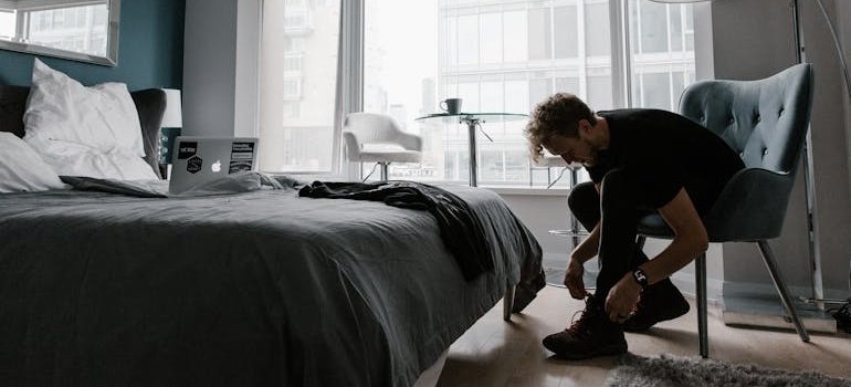 Man tying his shoes.