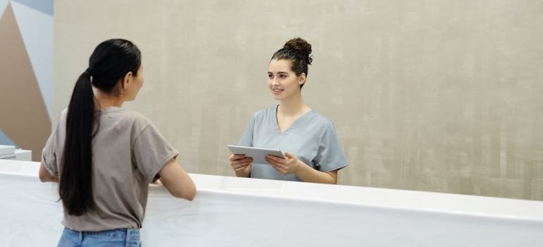 Woman talking to a nurse.