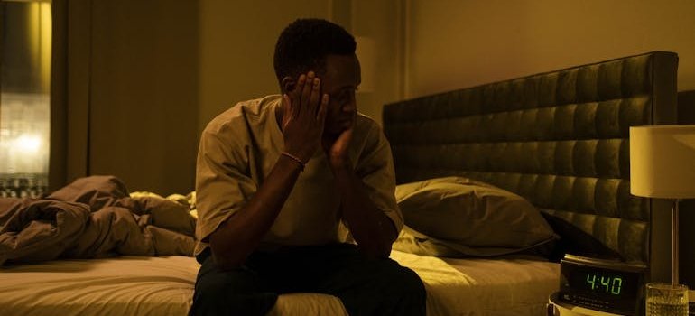 Man experiencing sleep issues because of depression and addiction.