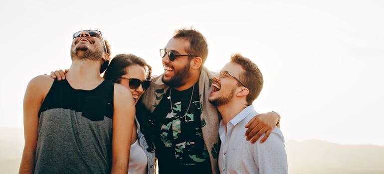 Group of friends laughing and hugging.
