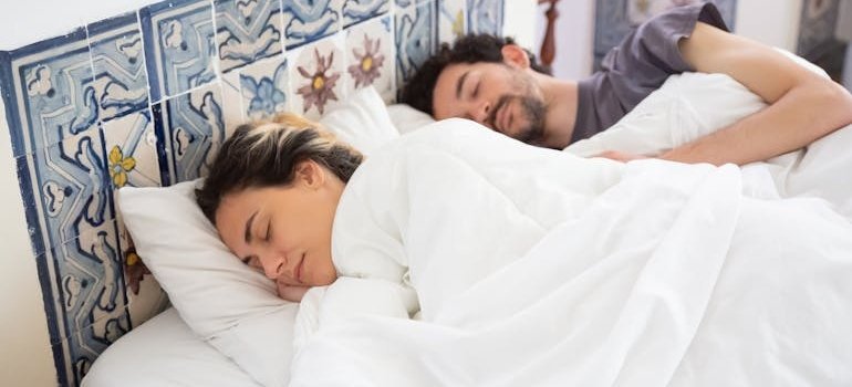 Couple sleeping together in their bedroom.