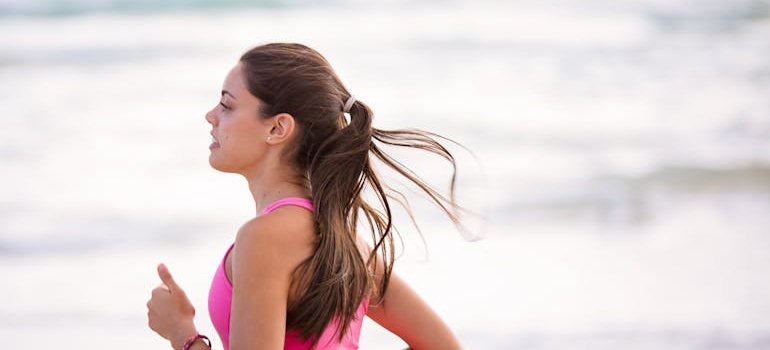 Woman jogging along the beachside.
