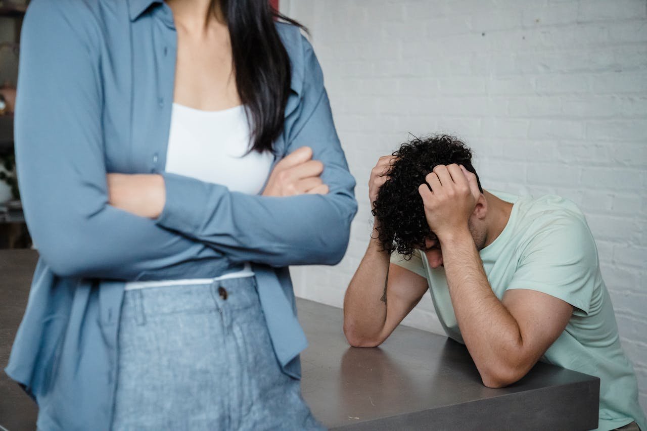 Man holding his head in his hands after a fight with his partner.