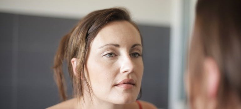 Woman looking at herself in the mirror.