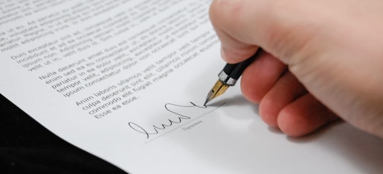 Person signing a document.