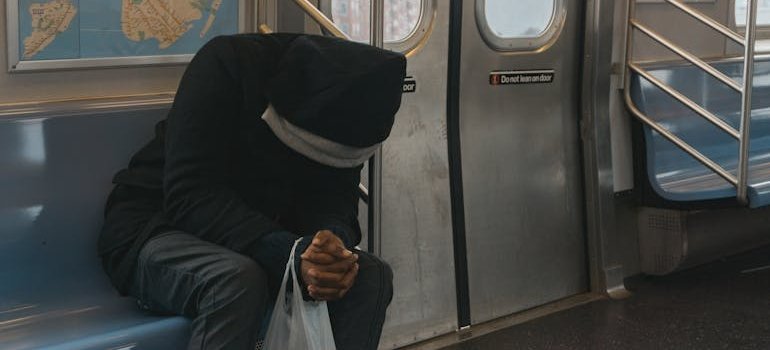 Tired man sitting on the subway.