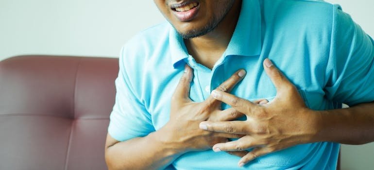 Man clutching his chest in pain.