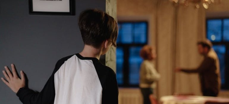 Young boy watching his parents having an argument.