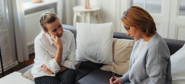 Woman crying while talking to a therapist.